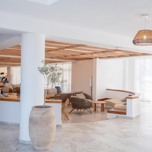 a white room with a wicker lamp hanging from the ceiling