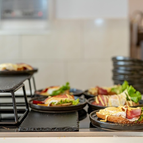 a bottle of sauce sits next to a tray of food