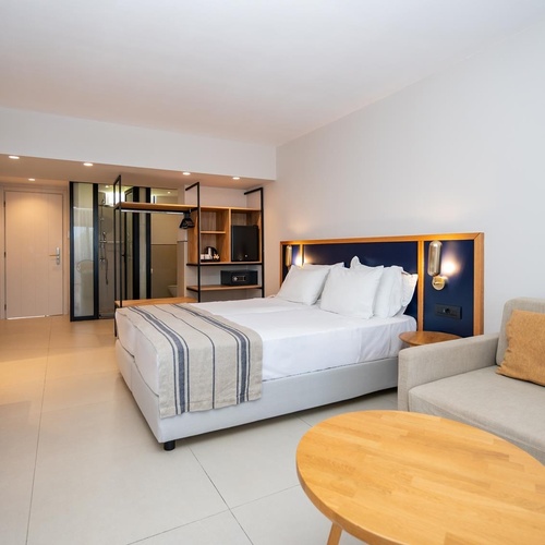 a hotel room with a large bed and a couch