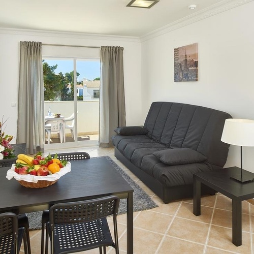 the word home is on the wall above the couch