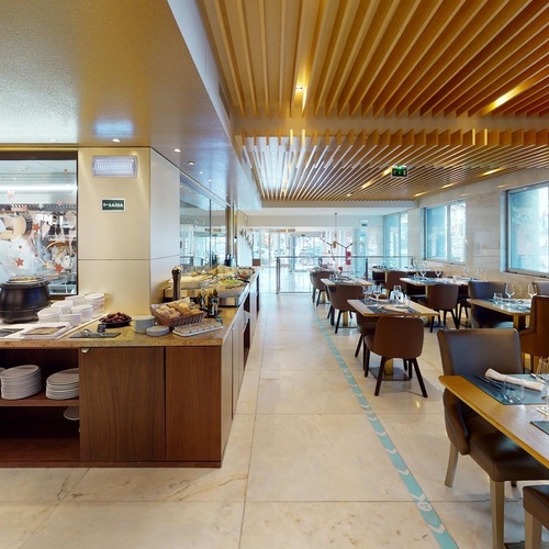 a restaurant with a green exit sign on the wall