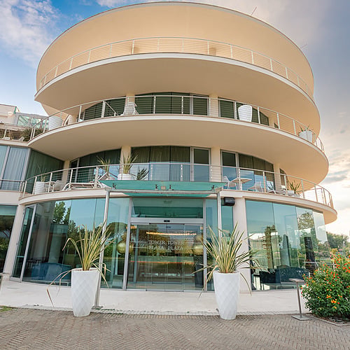 Extérieur moderne du Smy: Corporativa avec balcons arrondis et vitrines lumineuses.