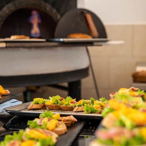 a pizza oven with a flame coming out of it