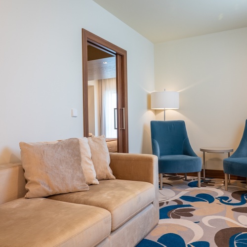 a living room with a couch and two chairs