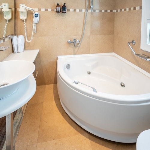 a bathroom with a jacuzzi tub and a sink