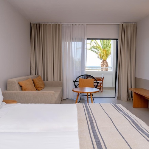 a hotel room with a bed a couch and a table