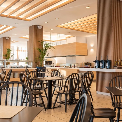 a restaurant with tables and chairs and a buffet