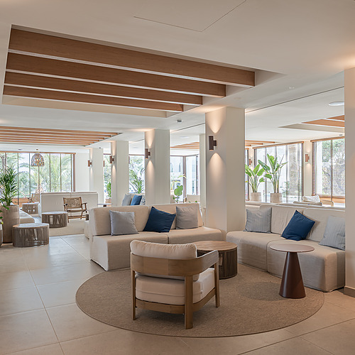 Stylish Smy: Corporativa hotel lobby with central olive tree and circular seating.