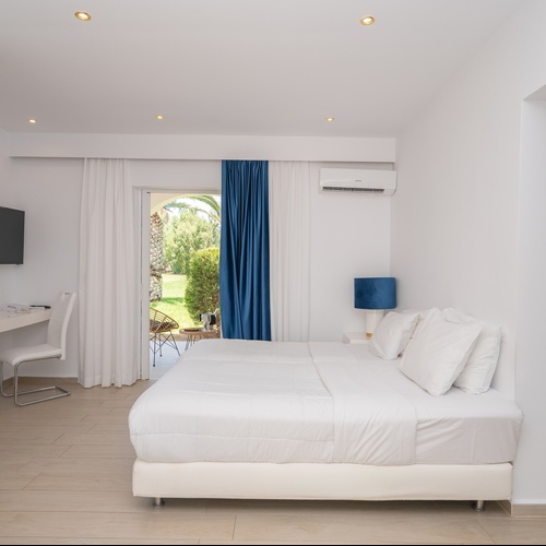 a hotel room with a bed and a television