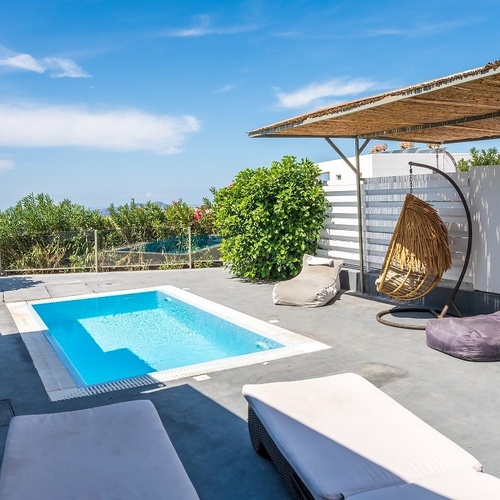 a small swimming pool in the backyard of a house