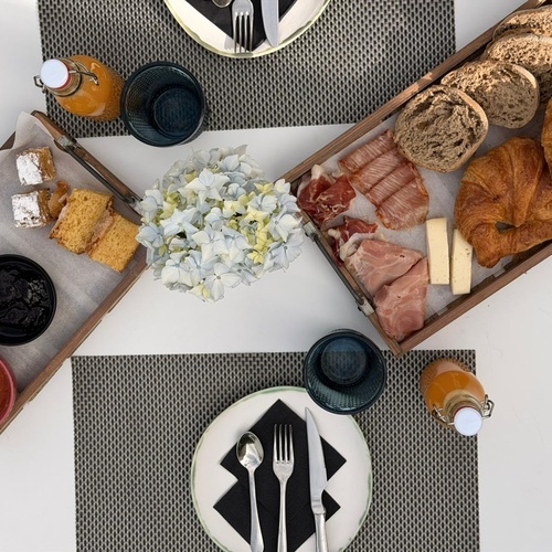 Desayuno de lujo en Pazo de Adran: croissants, embutidos, pasteles y flores frescas.
