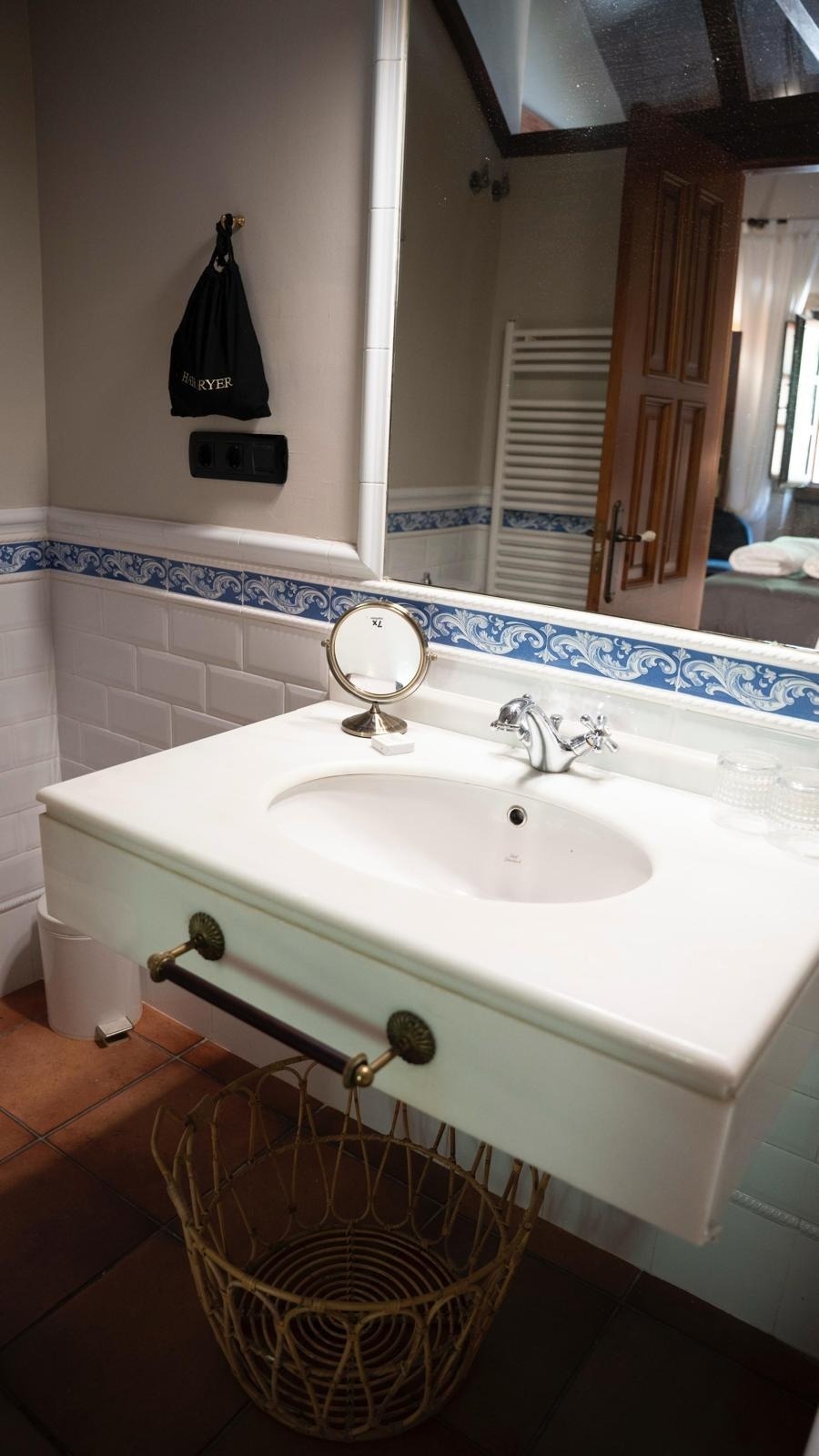 un baño con un lavabo y un espejo y una bolsa negra con la palabra forever