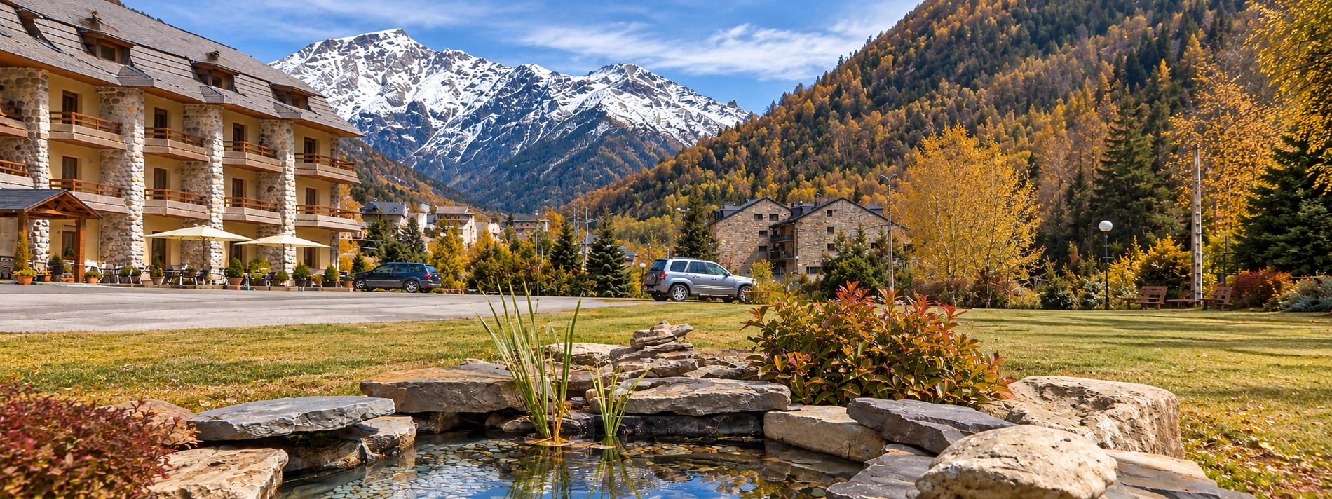SNO: Bielsa hotel with mountain views and pond.
