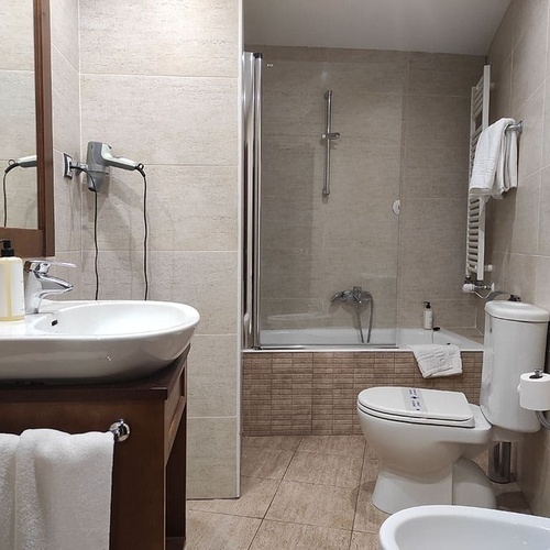 a bathroom with a toilet a sink and a bathtub