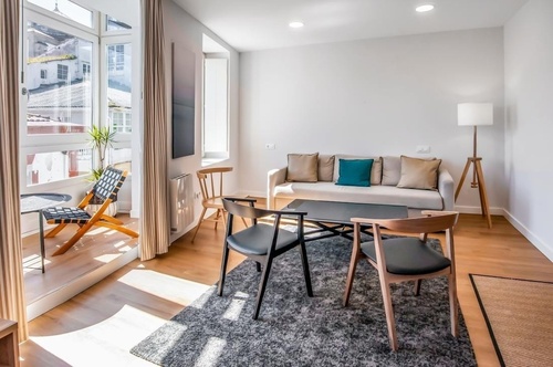 a living room with a couch a table and chairs
