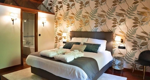 a hotel room with two beds and a painting on the wall