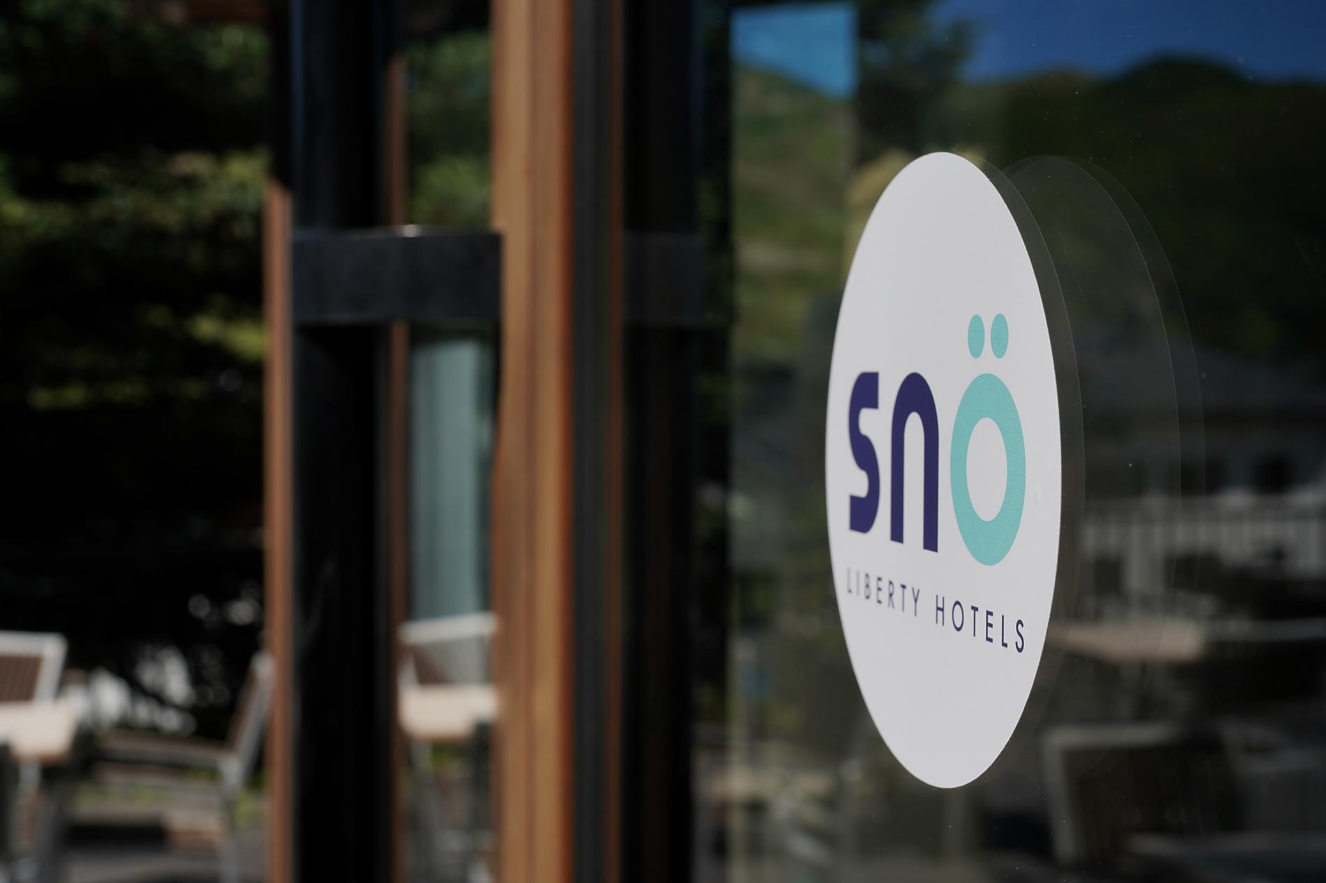 SNO Blog | SNO Hotels: Hands typing on laptop, cozy winter vibe.