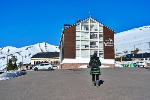 a woman stands in front of the hotel la corza blanca