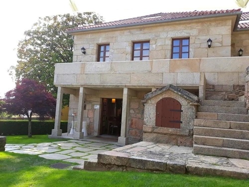 a stone house with stairs leading up to it