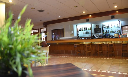 una mesa en un restaurante con botellas de vino y un menú