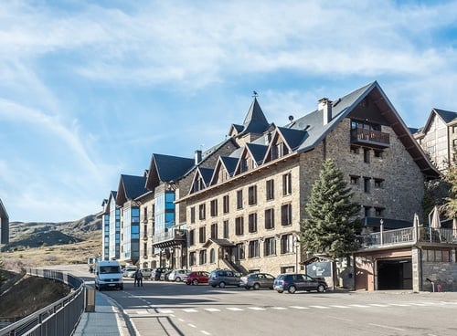 a white van is parked in front of a large stone building