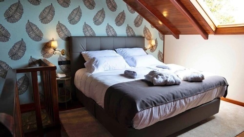 a hotel room with two beds and a crib