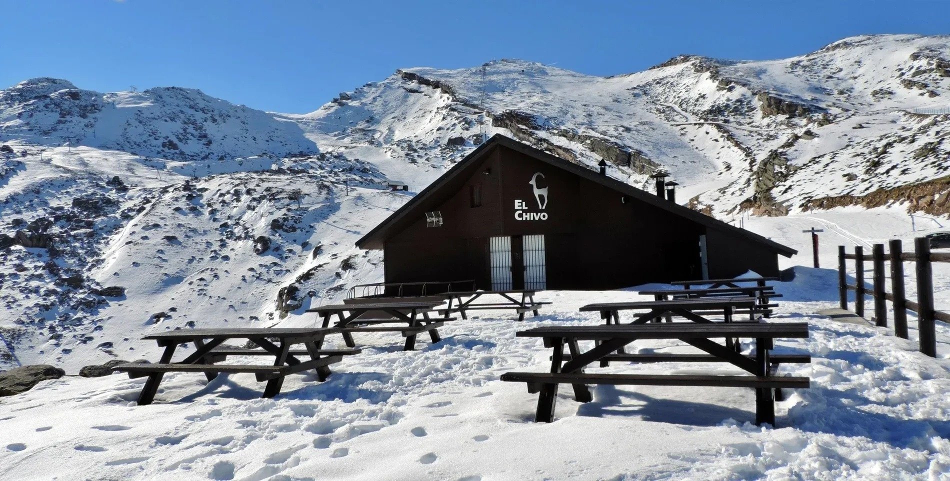 a snowy mountain with a building that says el chivo