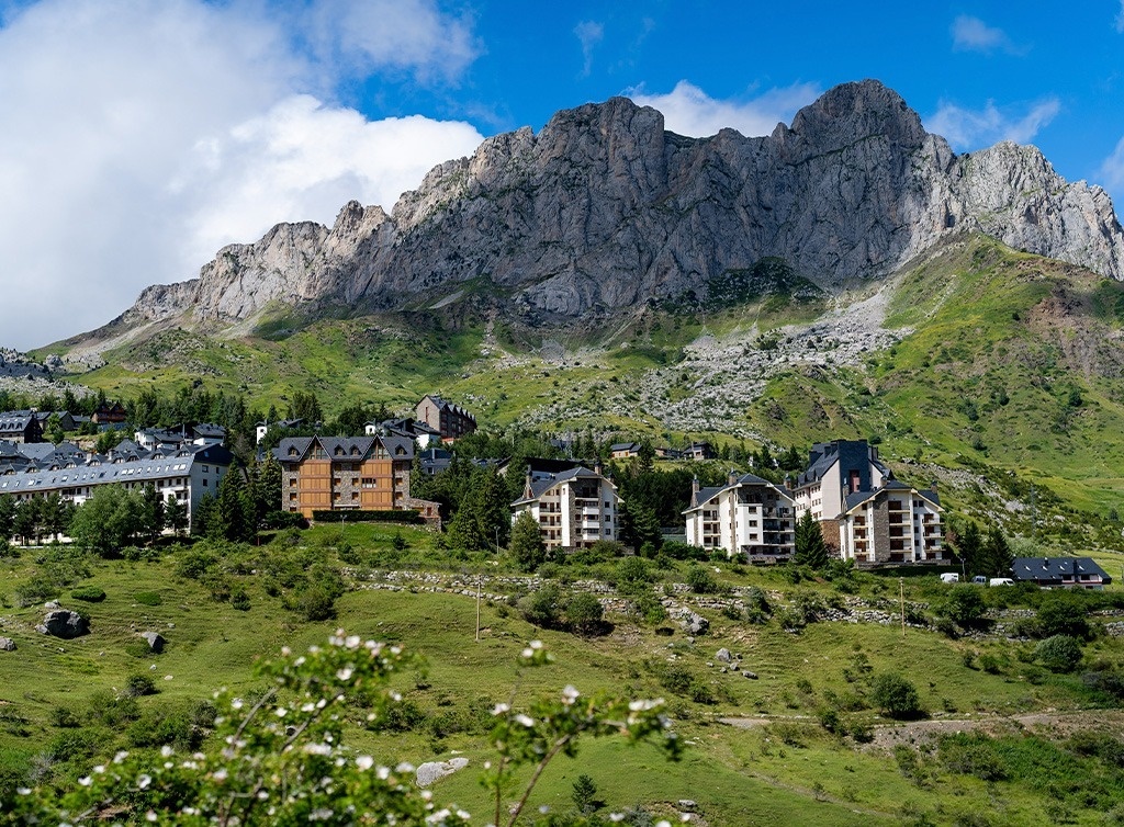 a mountain with a few buildings in the foreground