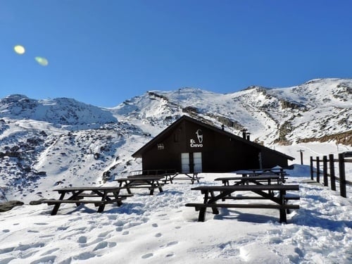 a snowy mountain with a building that says el cervo