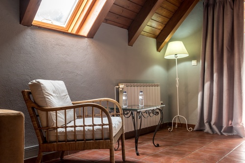 a bedroom with a red and white blanket on the bed