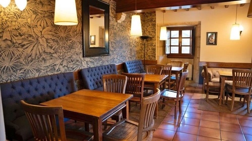 a dining room with tables and chairs and a picture on the wall