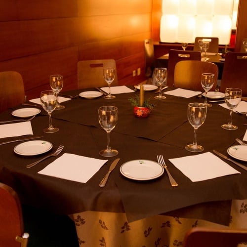 una mesa redonda con platos y copas de vino