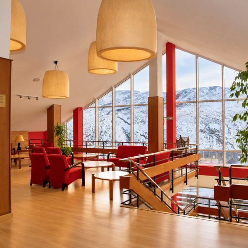 Chic SNO: La Corza Blanca lobby with snowy mountain views.