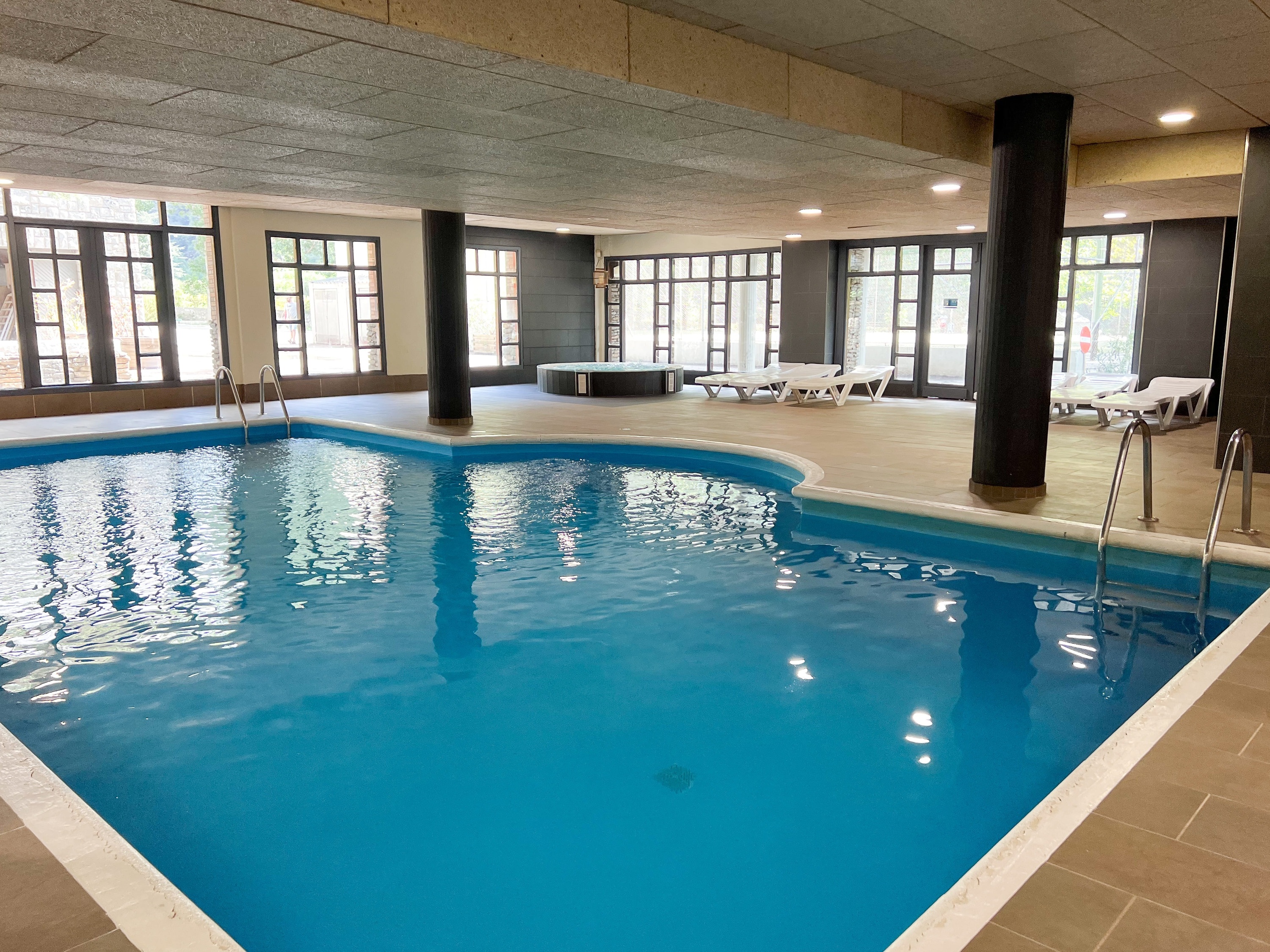 a hot tub in a room with a lot of windows