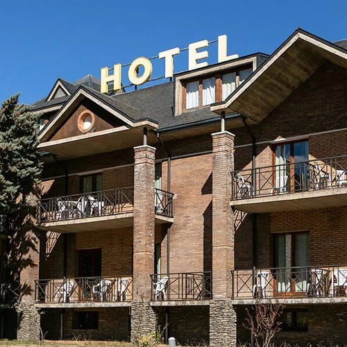 Hotel Condes de Pallars: main facade with balconies and 'Hotel' sign.