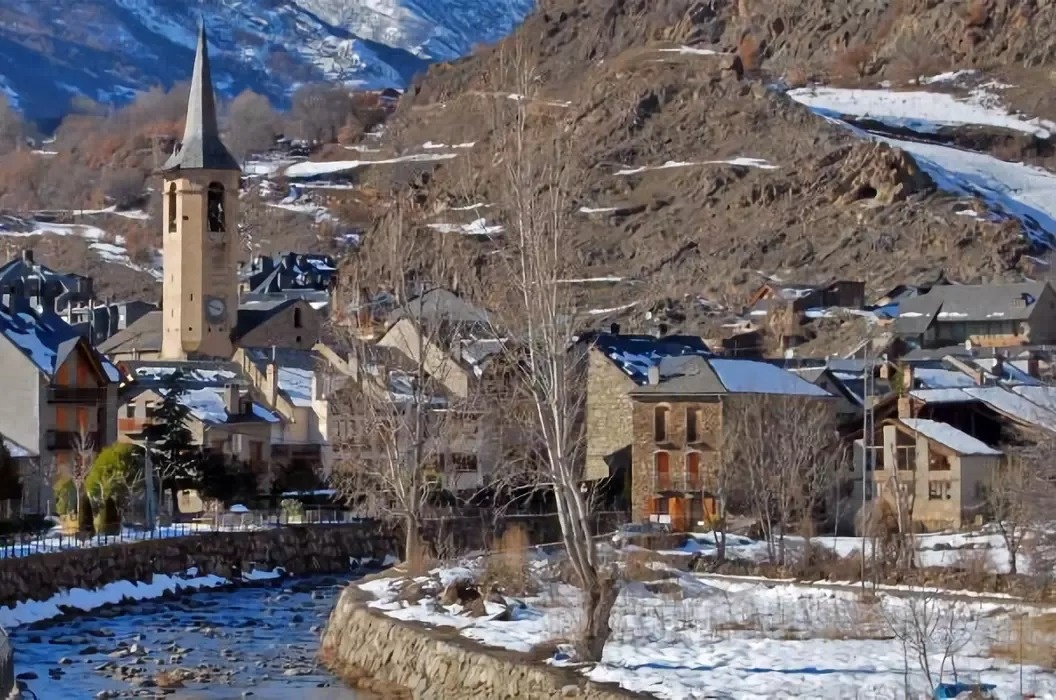 a person flying a parachute over a mountain range