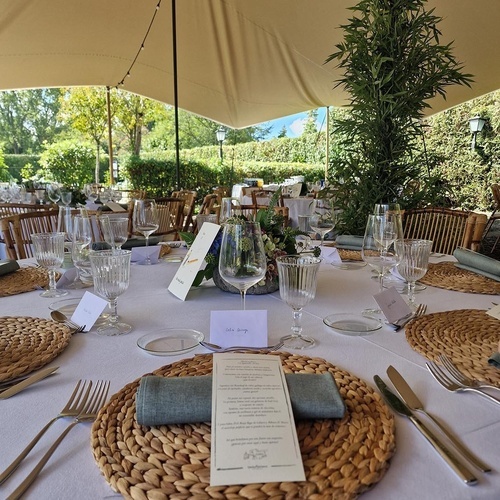 une table avec un menu et des verres de vin