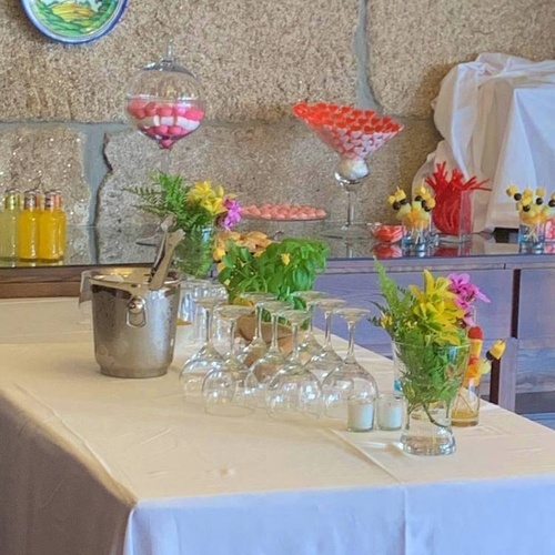 a table with wine glasses and flowers on it