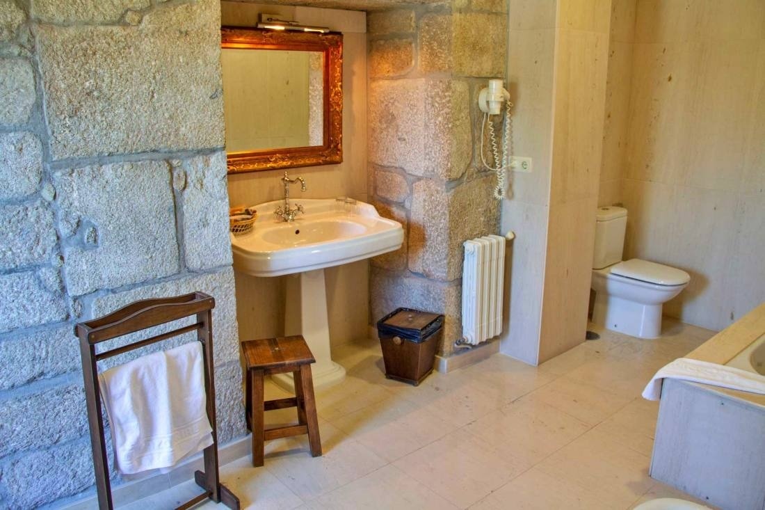 a bathroom with a pedestal sink and a toilet