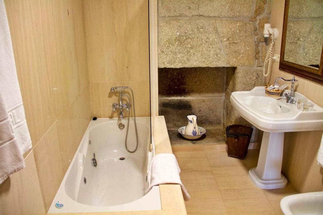 a bathroom with a jacuzzi tub and a sink