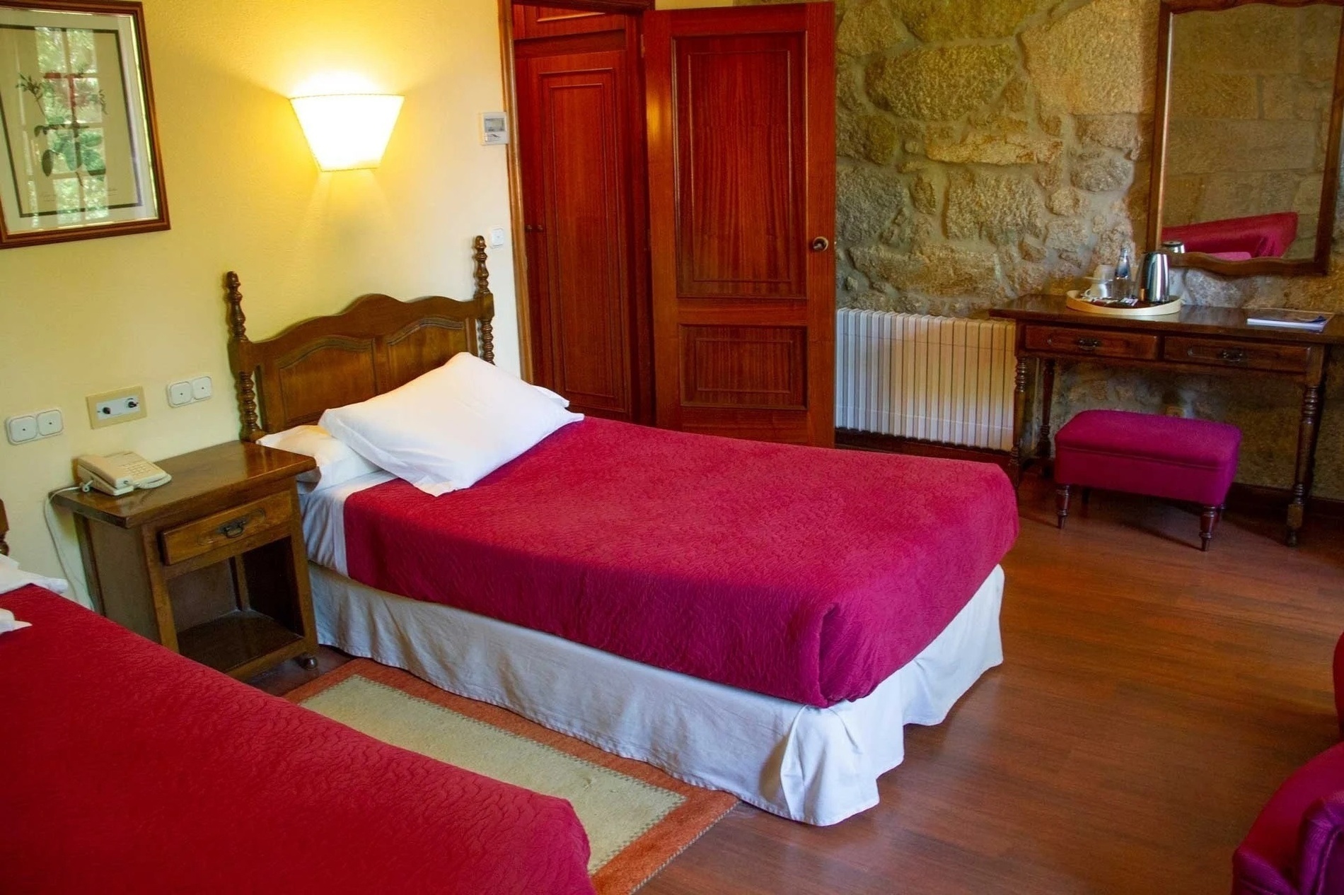 a hotel room with two beds and a desk