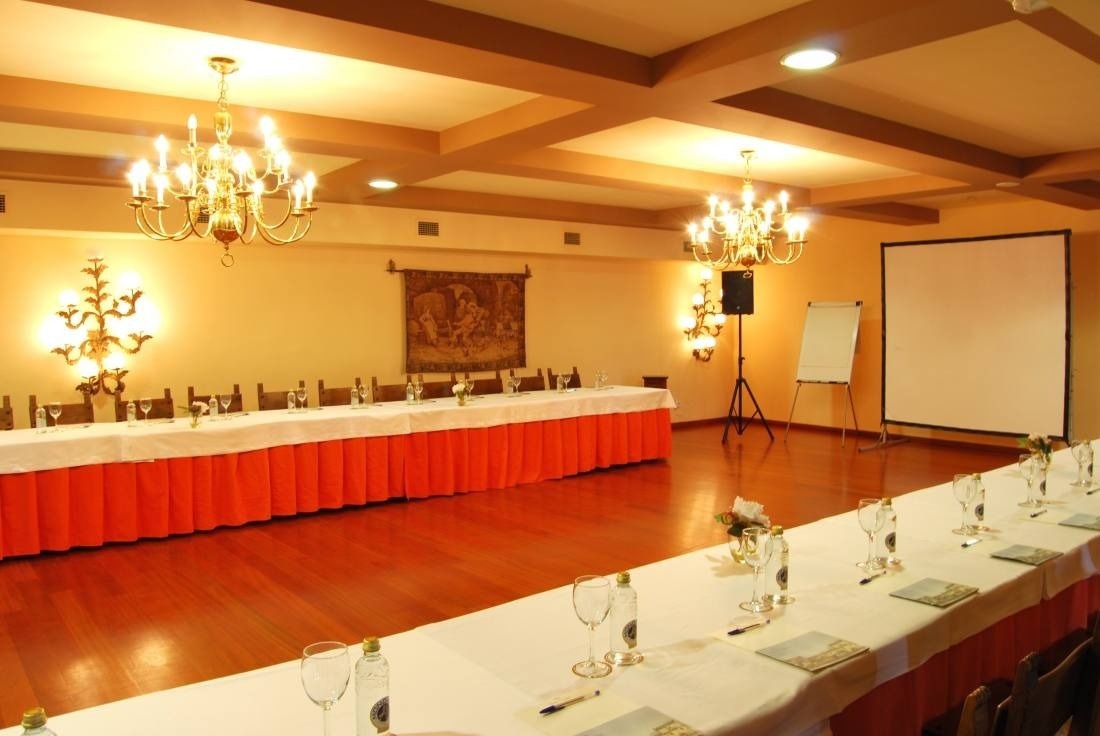 a long table in a room with a projector screen