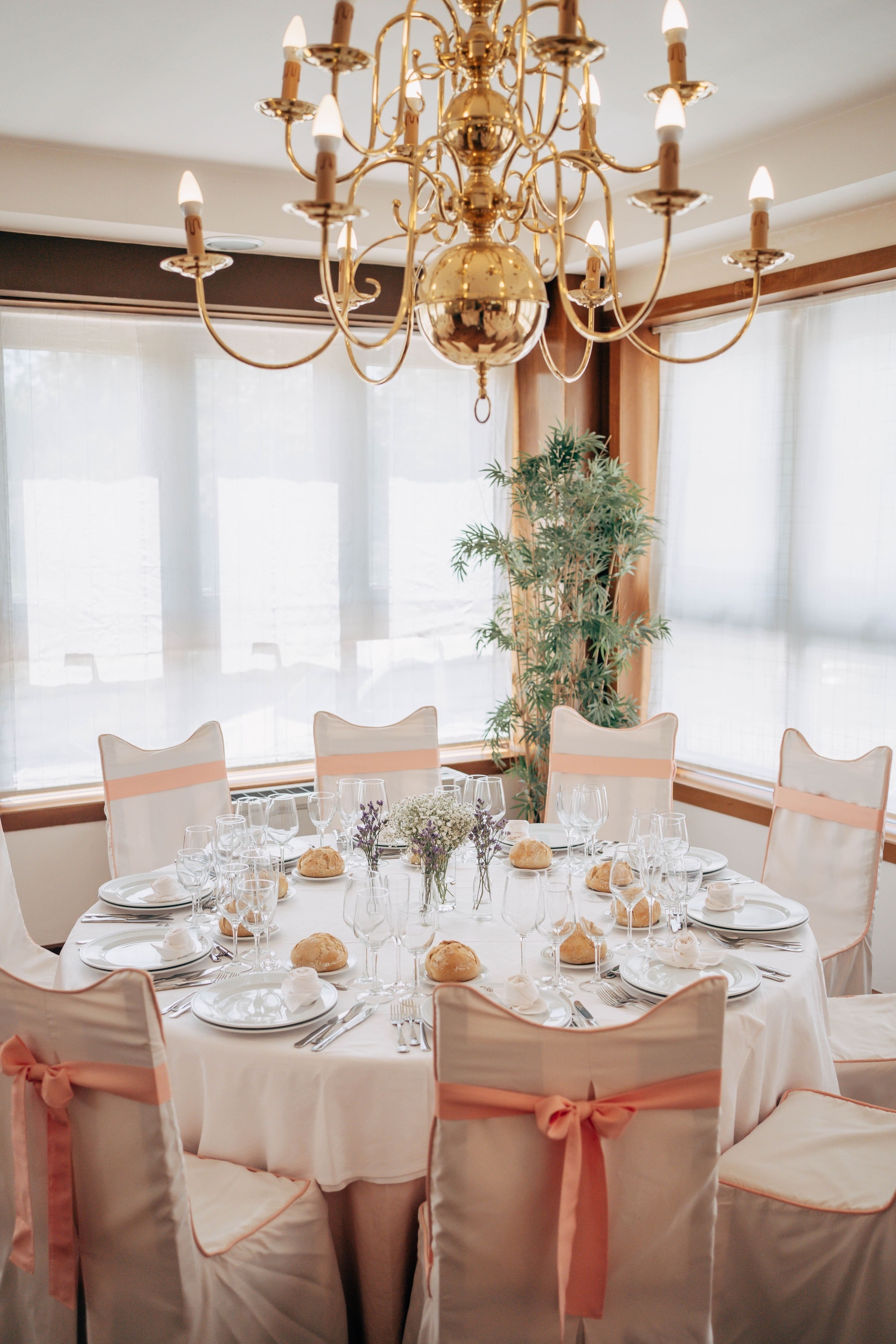 a long table in a room with a projector screen