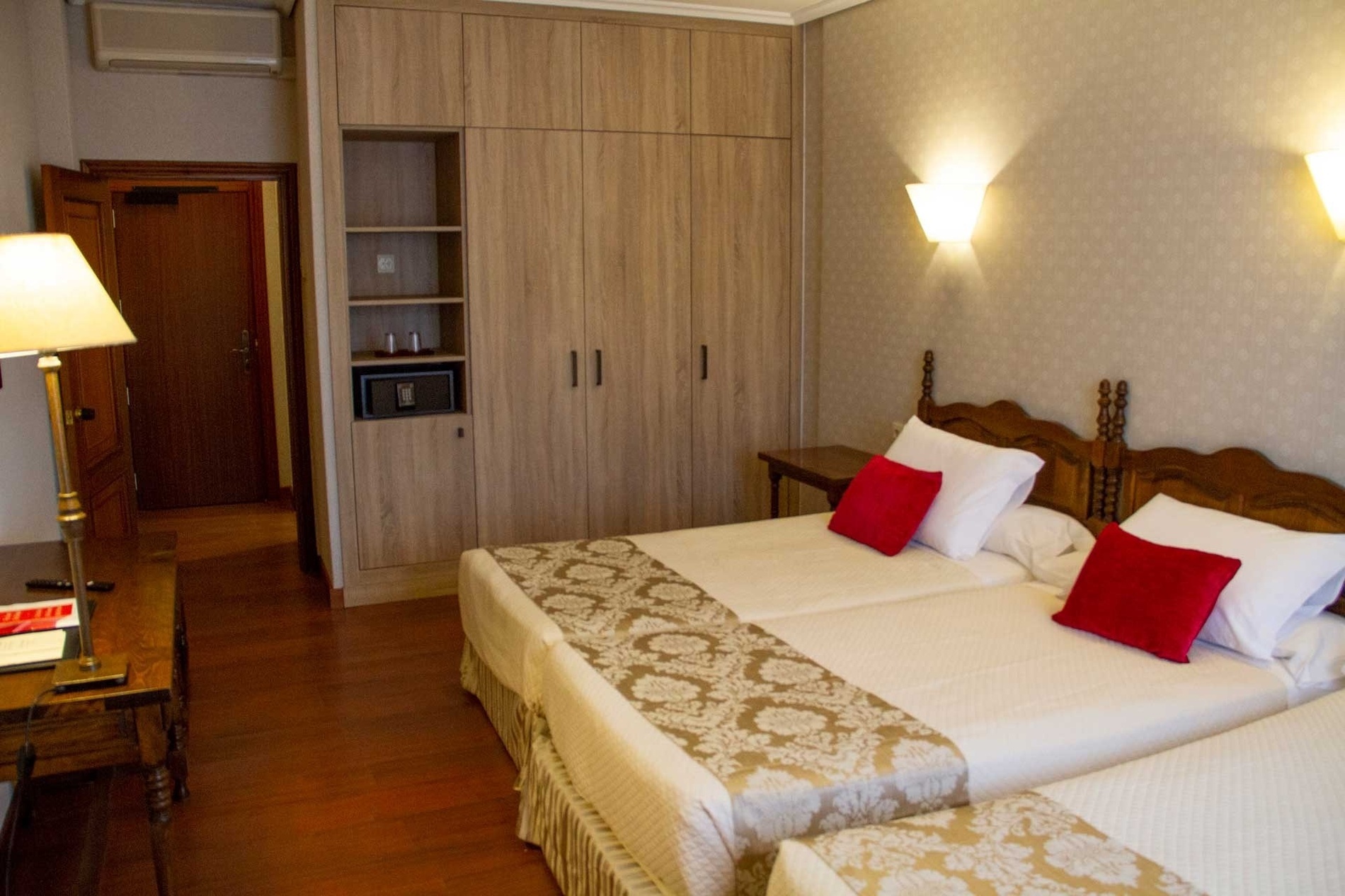 a hotel room with two beds and a door