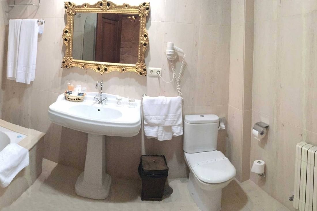 a bathroom with a sink toilet and a mirror