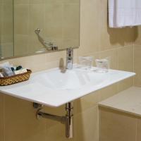 un baño cun lavabo e unha bañeira e un espello