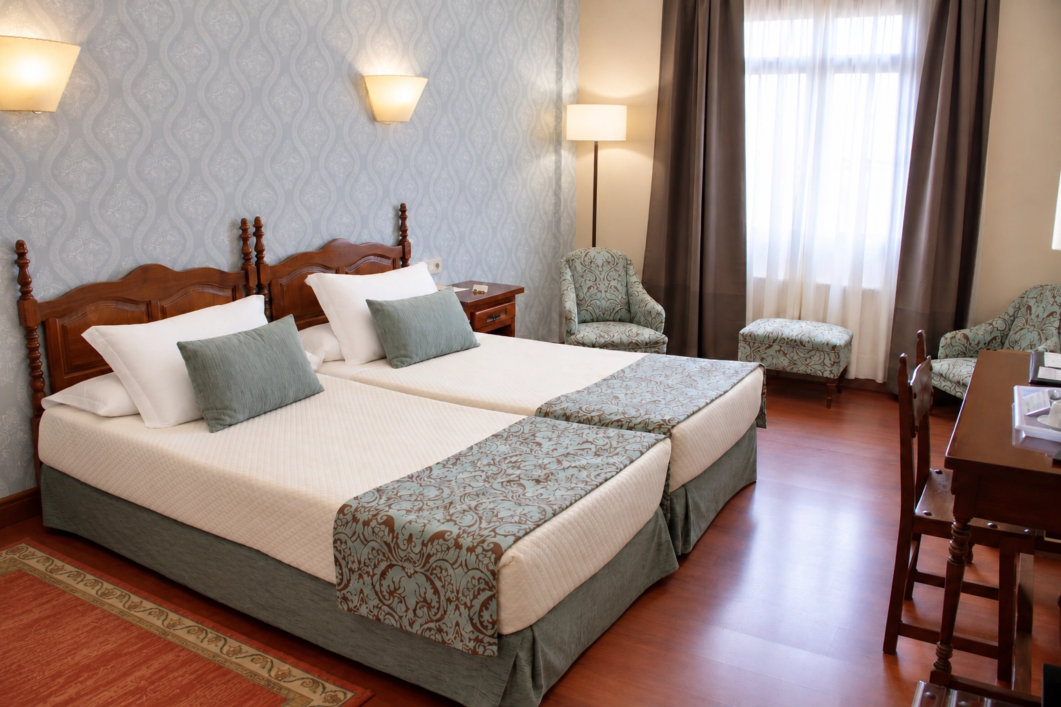 unha habitación de hotel con dúas camas e unha mesa