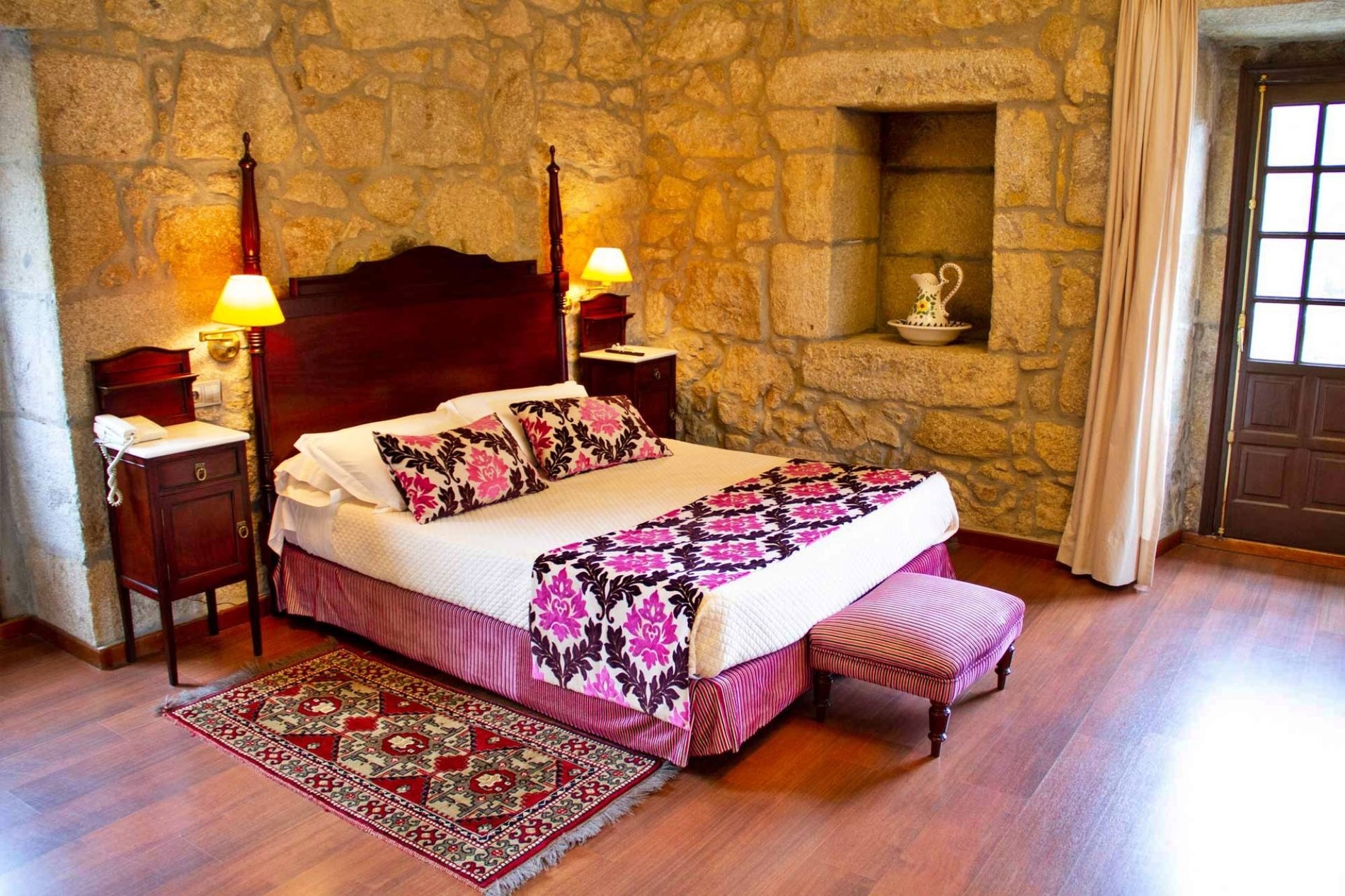 a bedroom with a bed and a rug on the floor