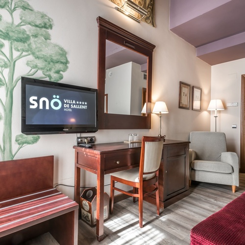 a hotel room with a television that says sno on it