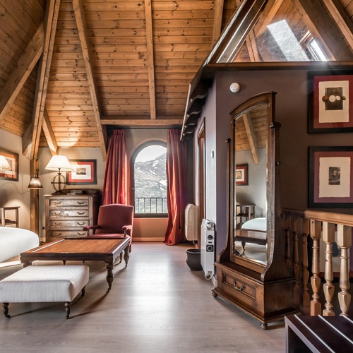 a living room with a couch a chair and a mirror